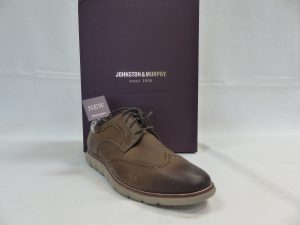 Brown shoe sitting in front of shoe box that says ‘Johnston & Murphy”
