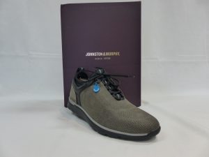 One sneaker sitting in front of shoe box that says “Johnston & Murphy”