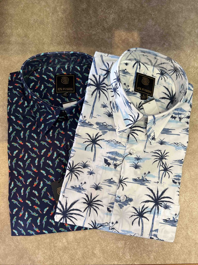 One blue patterned button-down shirt and one white tropical-patterned shirt