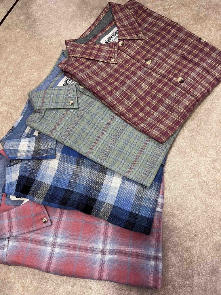 Group of four button-down shirts – one red plaid, one blue plaid, one gray plaid, and one dark red plaid