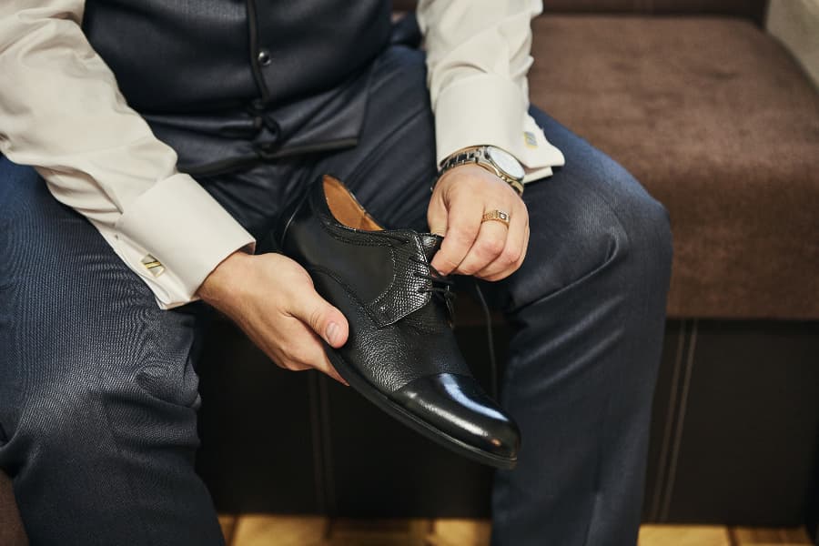 Businessman getting ready for work with fashionable footwear